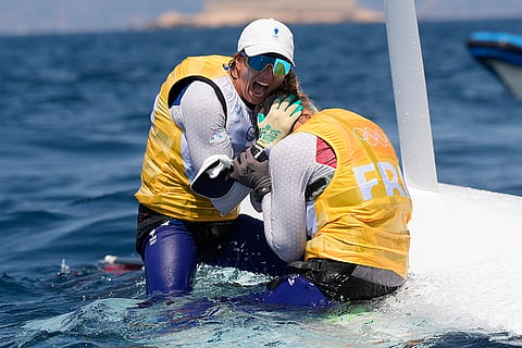 France team celebrate clinching the bronze medal in women's skiff race